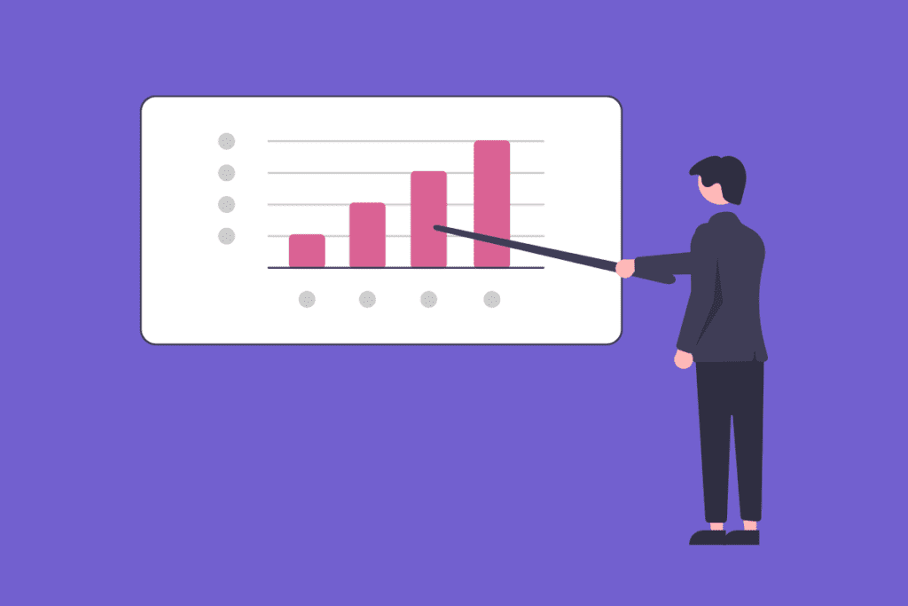 A man in a suit pointing at a chart on a whiteboard, discussing business strategies.